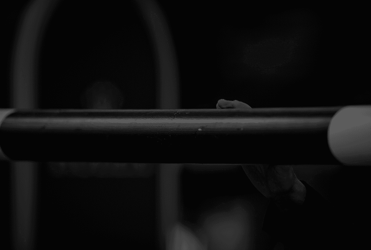 Horse jumping a show jumping fence under a spotlight